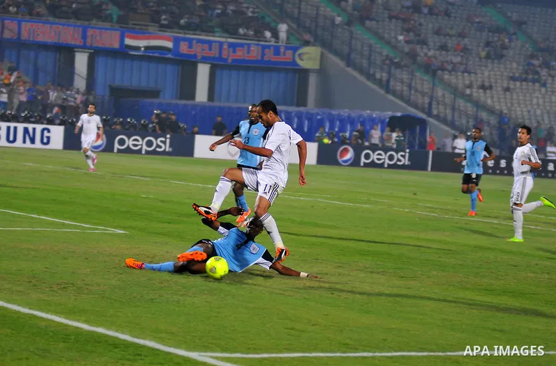 Egyptian players compete against with Botswana players during the qualifying match of 2015 Africa Cup soccer match, in Cairo, capital of Egypt, on Oct. 15, 2014. Egypt won the match with 2-0. Photo by Amr Sayed