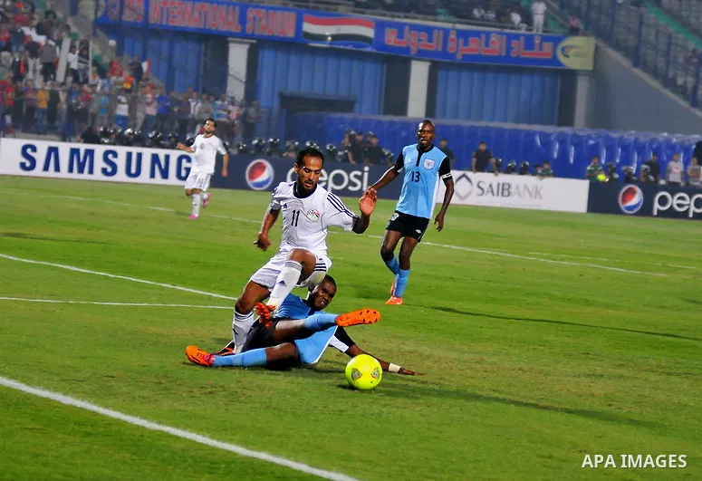 Egyptian players compete against with Botswana players during the qualifying match of 2015 Africa Cup soccer match, in Cairo, capital of Egypt, on Oct. 15, 2014. Egypt won the match with 2-0. Photo by Amr Sayed