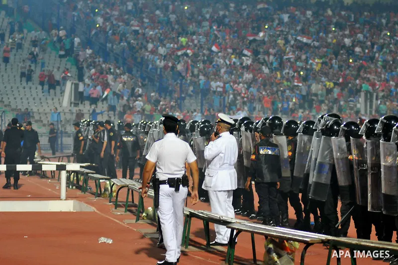 Egyptian soccer fans known as "Ultras" shout slogans against the government and police while holding a flare during the African Nations Cup qualifying soccer match between Egypt and Botswana, in Cairo October 15, 2014. T...