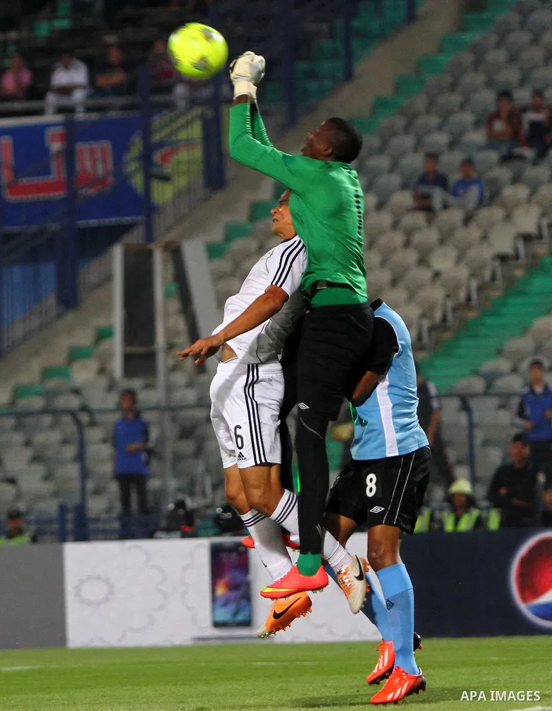 Egyptian players compete against with Botswana players during the qualifying match of 2015 Africa Cup soccer match, in Cairo, capital of Egypt, on Oct. 15, 2014. Egypt won the match with 2-0. Photo by Amr Sayed