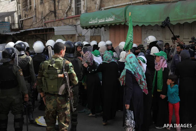 Palestinian supporters of Hamas clash with Palestinian security forces as they try to reach the Israeli checkpoint, in a protest against Israel restrictions at the Al-Aqsa Mosque compound in the city centre of the West B...