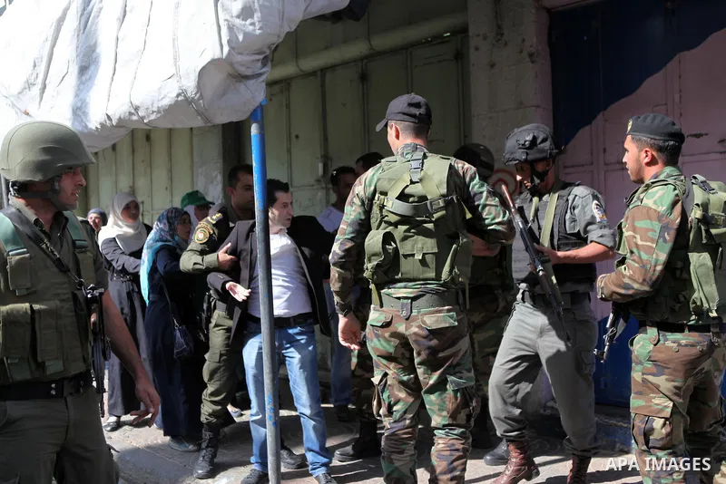 Members of the Palestinian security forces detain a Palestinian demonstrator during clashes after Hamas supporters tried to reach the Israeli checkpoint, in a protest against Israel restrictions at the Al-Aqsa Mosque com...