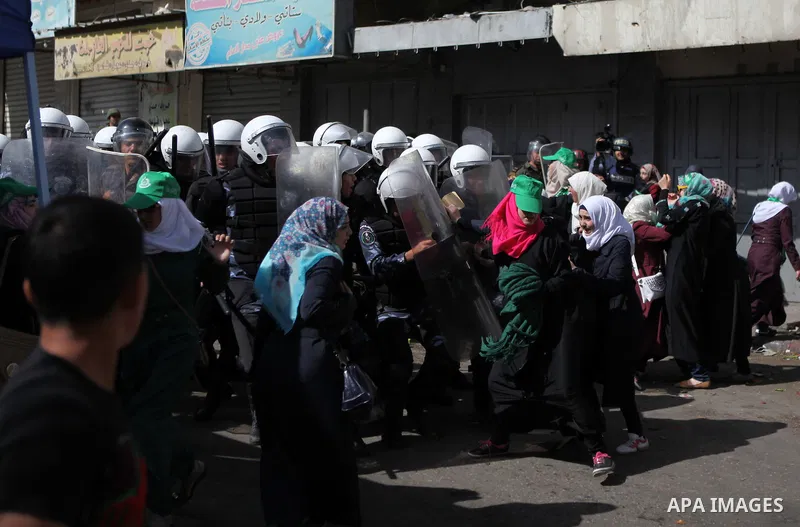 Palestinian supporters of Hamas clash with Palestinian security forces as they try to reach the Israeli checkpoint, in a protest against Israel restrictions at the Al-Aqsa Mosque compound in the city centre of the West B...