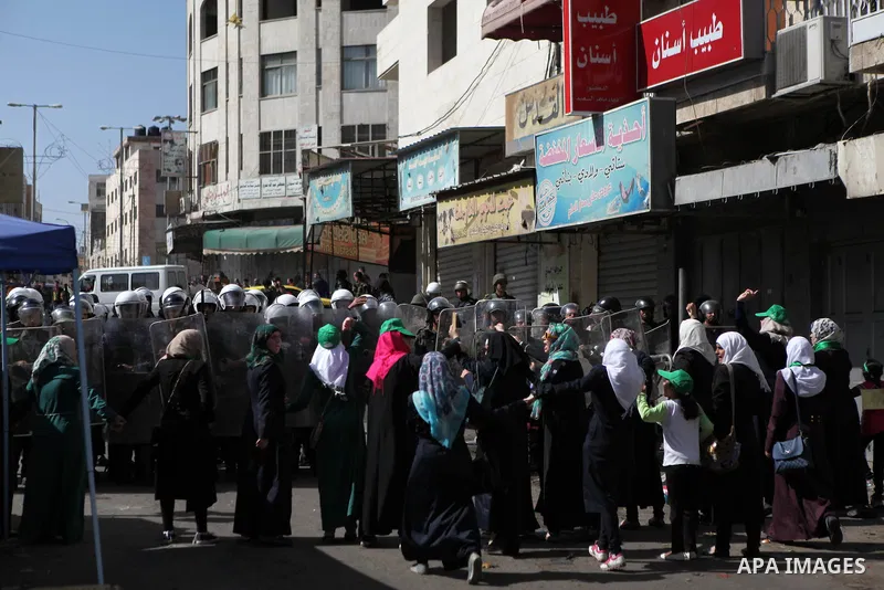 Palestinian supporters of Hamas clash with Palestinian security forces as they try to reach the Israeli checkpoint, in a protest against Israel restrictions at the Al-Aqsa Mosque compound in the city centre of the West B...