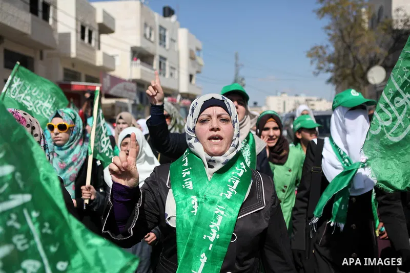 Palestinian supporters of Hamas take part in a protest against Israel restrictions at the Al-Aqsa Mosque compound in the city centre of the West Bank city of Hebron on October 17,2014. For the third week in a row, Israel...