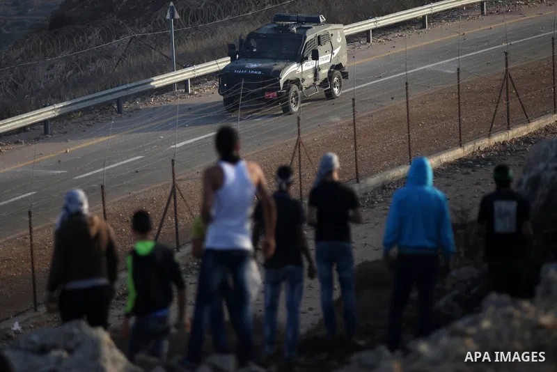 Palestinian protesters throw stones towards Israeli security forces during clashes at a protest to show solidarity with al-Aqsa mosque, outside Israel's Ofer military prison near the West Bank city of Ramallah October 17...