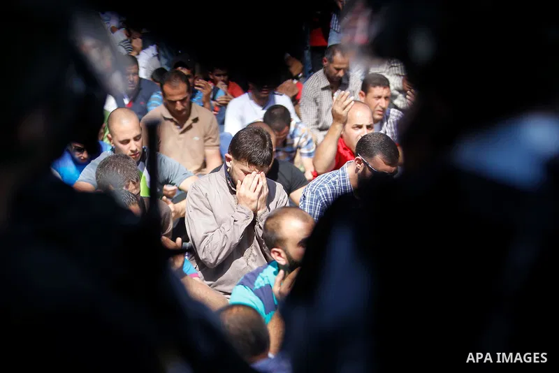 Israeli security forces stand guard as Palestinian Muslim worshipers perform traditional Friday prayers in a street outside the Old City in east Jerusalem on October 17, 2014. The Israeli government has restricted access...