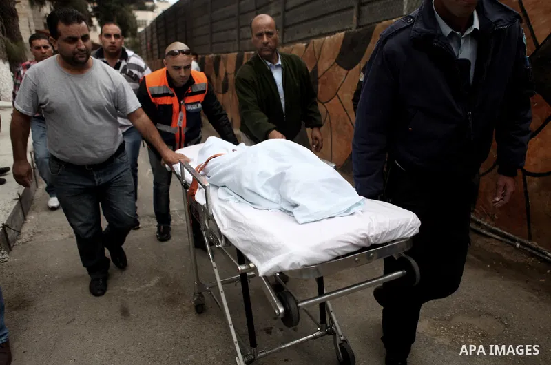 Medicals wheel the body of Palestinian kindergarten girl Inas Shawkat Khalil, 5, at a hospital in the West Bank city of Ramallah, October 19, 2014. Khalil died Sunday of her wounds, while another girl was seriously injur...