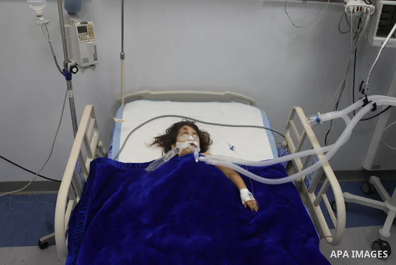 Palestinian kindergarten girl Toleen Omar Asfour, 5, lies at a hospital bed in the West Bank city of Ramallah, October 19, 2014. A kindergarten girl Sunday died of her wounds, while Asfour was seriously injured after an...