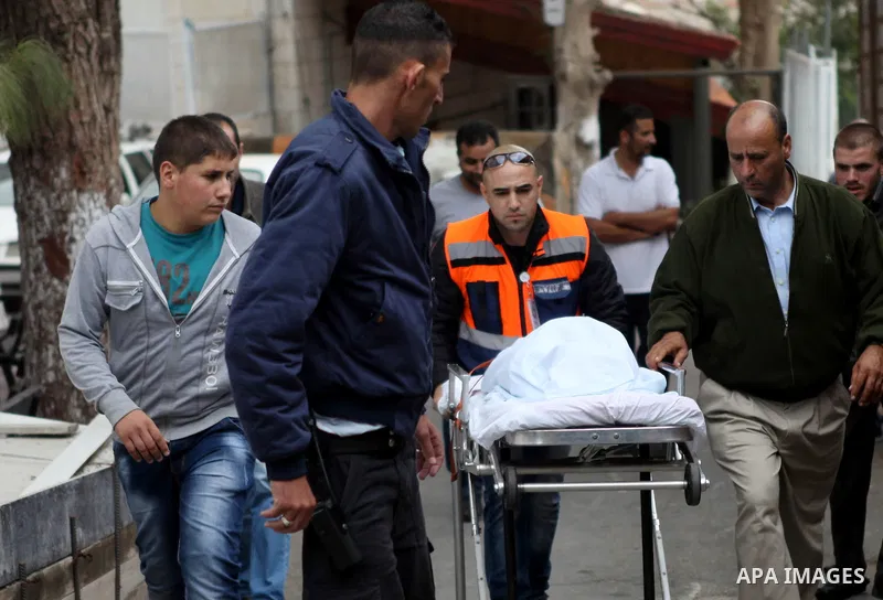 Medicals wheel the body of Palestinian kindergarten girl Inas Shawkat Khalil, 5, at a hospital in the West Bank city of Ramallah, October 19, 2014. Khalil died Sunday of her wounds, while another girl was seriously injur...