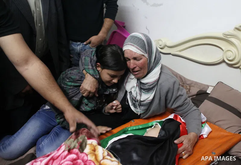 Relatives of Palestinian kindergarten girl Inas Shawkat Khalil, 5, mourn during her funeral in the West Bank village of Sinjel north of Ramallah, October 20, 2014. Khalil died Sunday of her wounds, while another girl was...