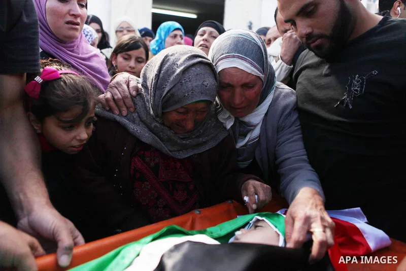 Relatives of Palestinian kindergarten girl Inas Shawkat Khalil, 5, mourn during her funeral in the West Bank village of Sinjel north of Ramallah, October 20, 2014. Khalil died Sunday of her wounds, while another girl was...
