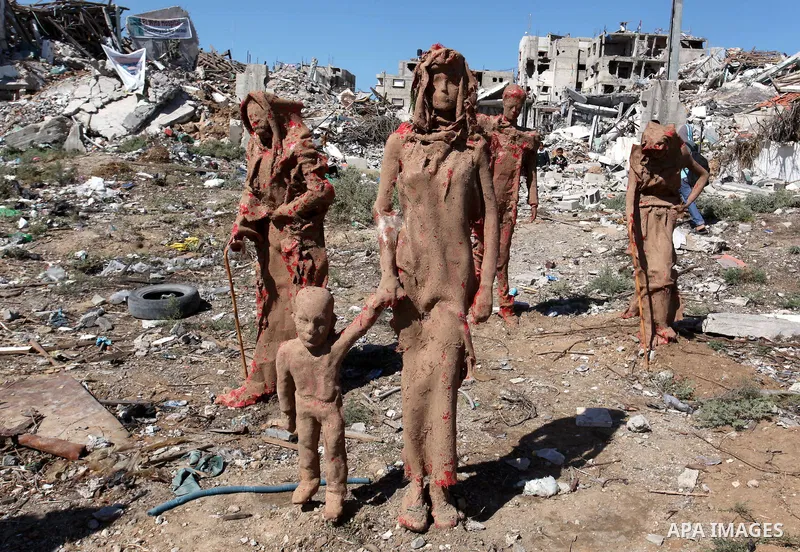 Statues by Palestinian artist Eyad Sabbah,40, stand amidst the rubble of buildings destroyed during the 50 days of conflict between Israel and Hamas last summer, in the Shejaiya neighborhood of Gaza City on October 21, 2...