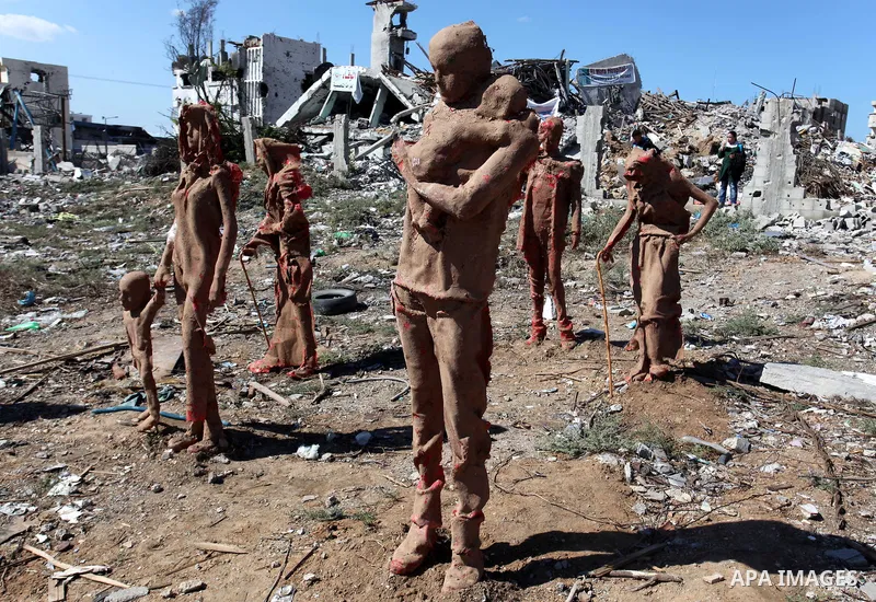 Statues by Palestinian artist Eyad Sabbah,40, stand amidst the rubble of buildings destroyed during the 50 days of conflict between Israel and Hamas last summer, in the Shejaiya neighborhood of Gaza City on October 21, 2...