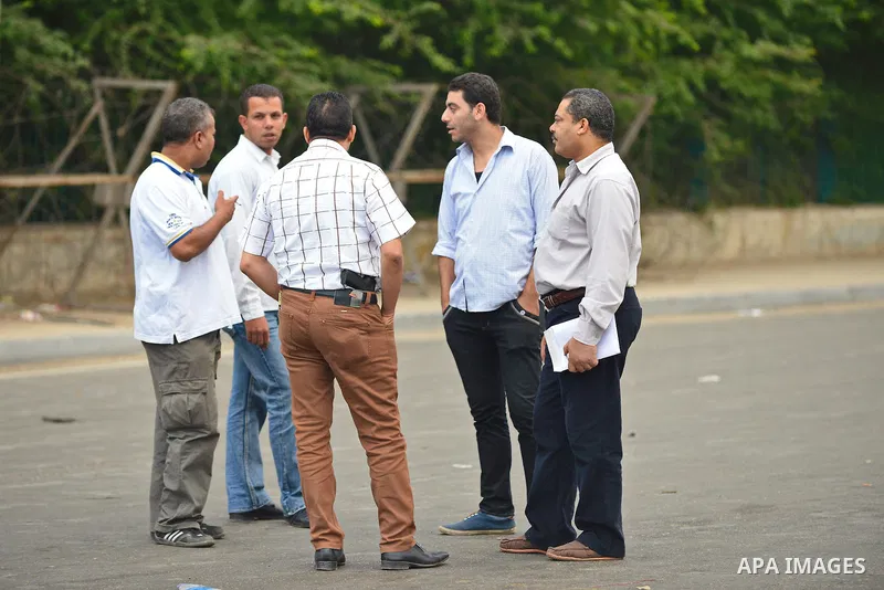 Egyptian policemen inspect the site where a bomb exploded outside the main gate of Cairo University on October 22, 2014, wounding at least nine people including a senior officer. The assistant police chief of Cairo's Giz...