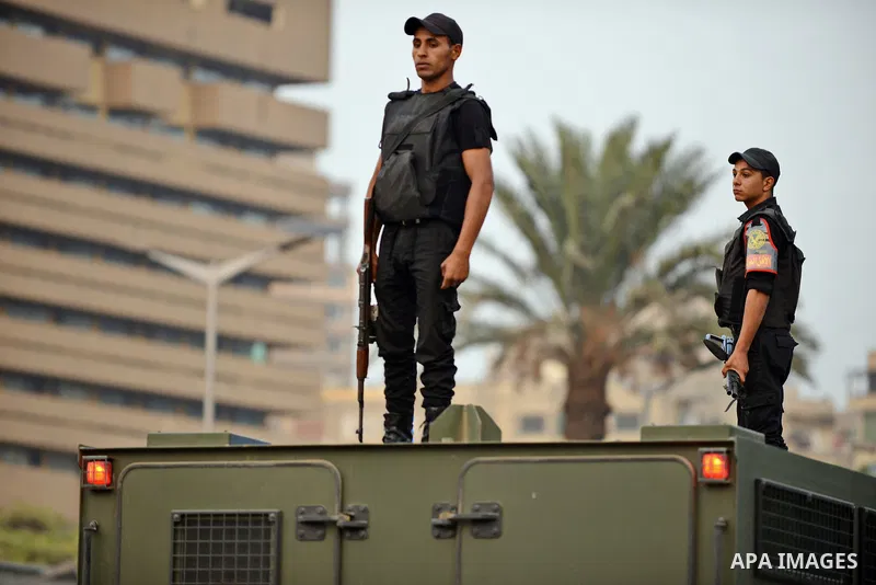 Members of Egyptian security forces monitor near Cairo University after a bomb exploded outside the main gate wounding at least nine people including a senior officer on October 22, 2014. The assistant police chief of Ca...