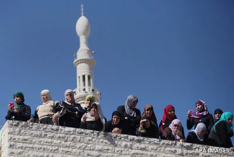 Relatives of Palestinian-American youth Orwah Hammad, whom medics said was killed by Israeli forces, watch his funeral in the West Bank village of Silwad near Ramallah October 26, 2014. Israeli forces shot and killed Ham...