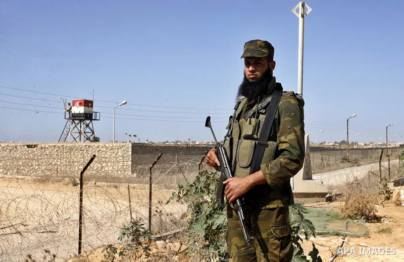 A Palestinian security officer patrols the Palestinian side of the Rafah border crossing in the southern Gaza Strip with Egypt (background) on October 26, 2014. The decision was taken to close the Rafah crossing into the...