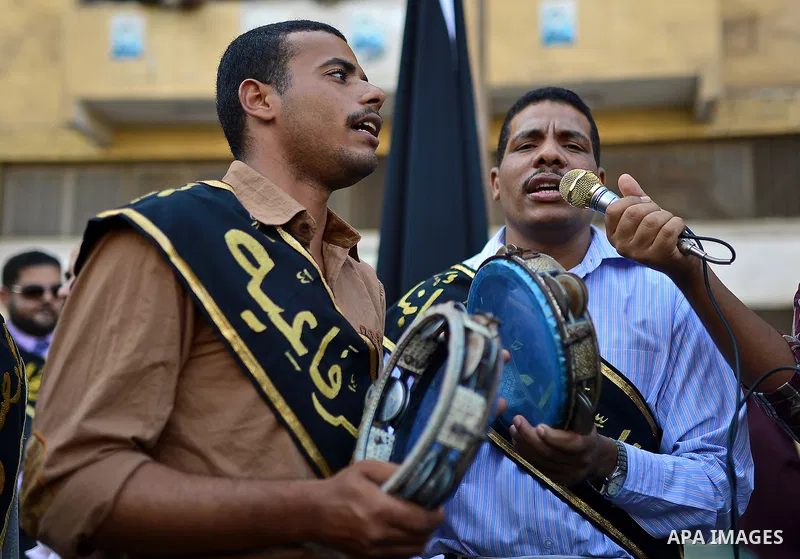 Members of Egyptian sufi muslim group play traditional instruments as they parade the street during a ritual to commemorate the Hijri New Year, also known as Islamic New Year, in Cairo on October 26, 2014. The Islamic ye...
