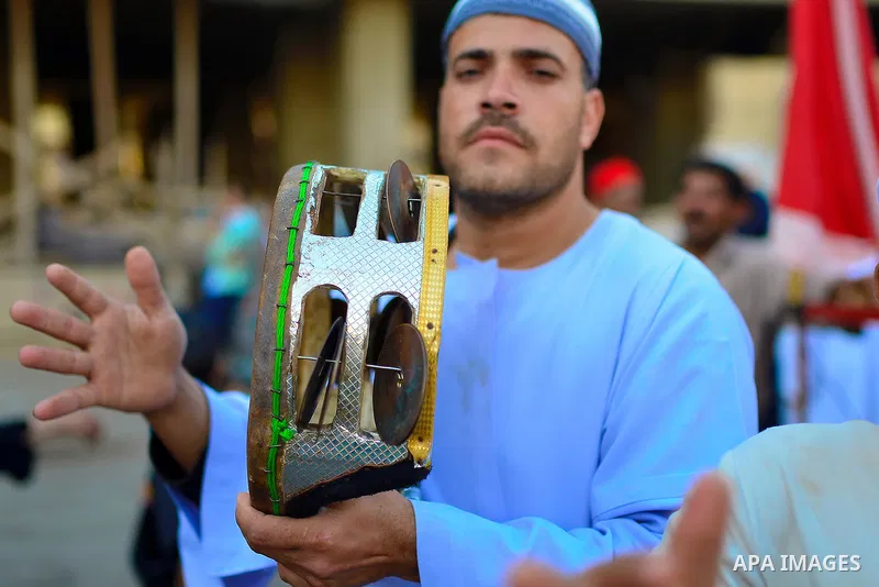 Members of Egyptian sufi muslim group play traditional instruments as they parade the street during a ritual to commemorate the Hijri New Year, also known as Islamic New Year, in Cairo on October 26, 2014. The Islamic ye...