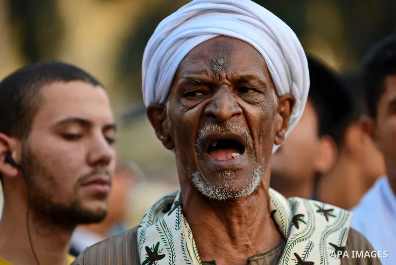 A member of Egyptian sufi muslim group performs as they parade the street during a ritual to commemorate the Hijri New Year, also known as Islamic New Year, in Cairo on October 26, 2014. The Islamic year lasts for about...