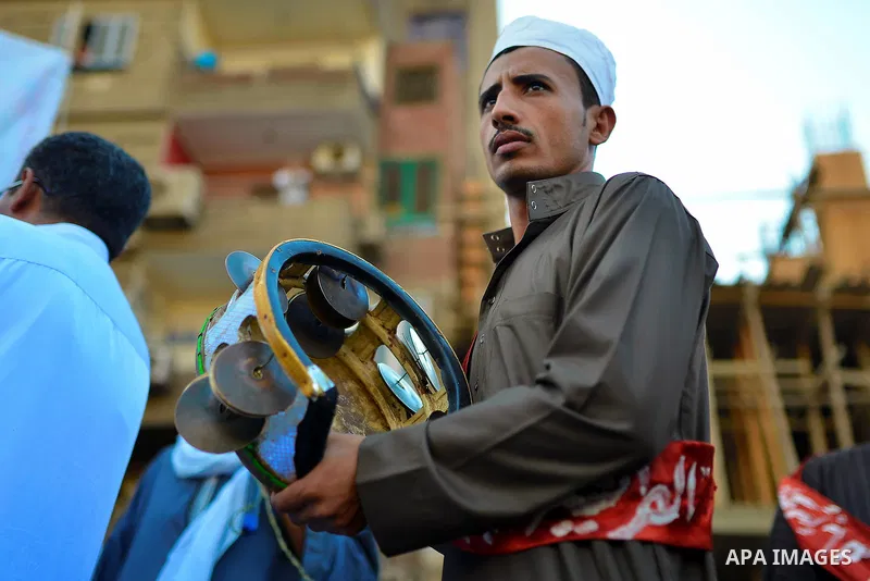 Members of Egyptian sufi muslim group play traditional instruments as they parade the street during a ritual to commemorate the Hijri New Year, also known as Islamic New Year, in Cairo on October 26, 2014. The Islamic ye...