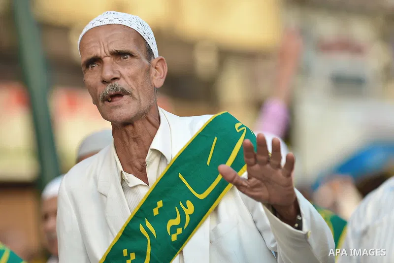 A member of Egyptian sufi muslim group performs as they parade the street during a ritual to commemorate the Hijri New Year, also known as Islamic New Year, in Cairo on October 26, 2014. The Islamic year lasts for about...