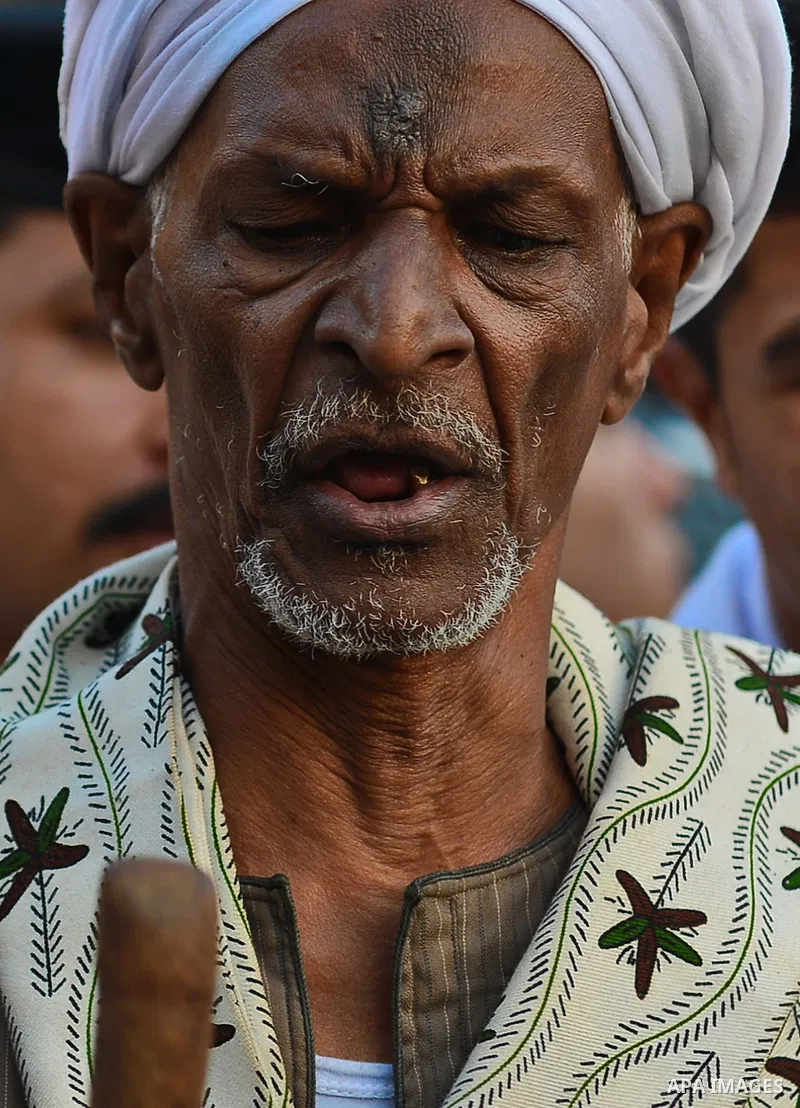 A member of Egyptian sufi muslim group performs as they parade the street during a ritual to commemorate the Hijri New Year, also known as Islamic New Year, in Cairo on October 26, 2014. The Islamic year lasts for about...