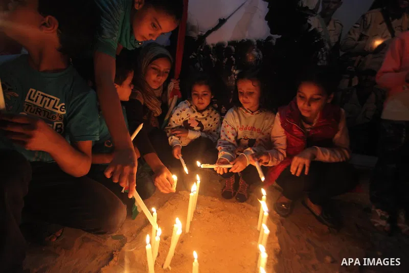 Palestinians light candles to mourn victims of the Egyptian soldiers killed in a suicide attack in Sinai on Friday, at the Egyptian community headquarter in Gaza city October 28, 2014. Cairo shut the vital crossing follo...