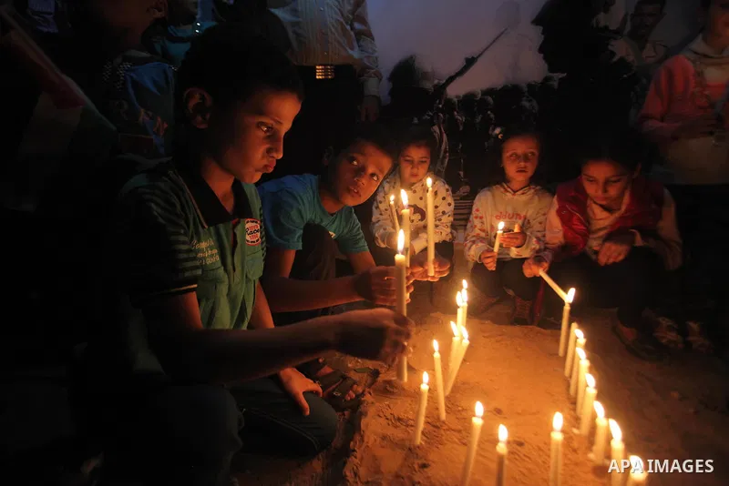 Palestinians light candles to mourn victims of the Egyptian soldiers killed in a suicide attack in Sinai on Friday, at the Egyptian community headquarter in Gaza city October 28, 2014. Cairo shut the vital crossing follo...