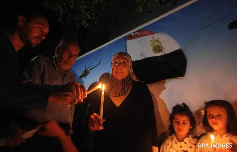 Palestinians light candles to mourn victims of the Egyptian soldiers killed in a suicide attack in Sinai on Friday, at the Egyptian community headquarter in Gaza city October 28, 2014. Cairo shut the vital crossing follo...