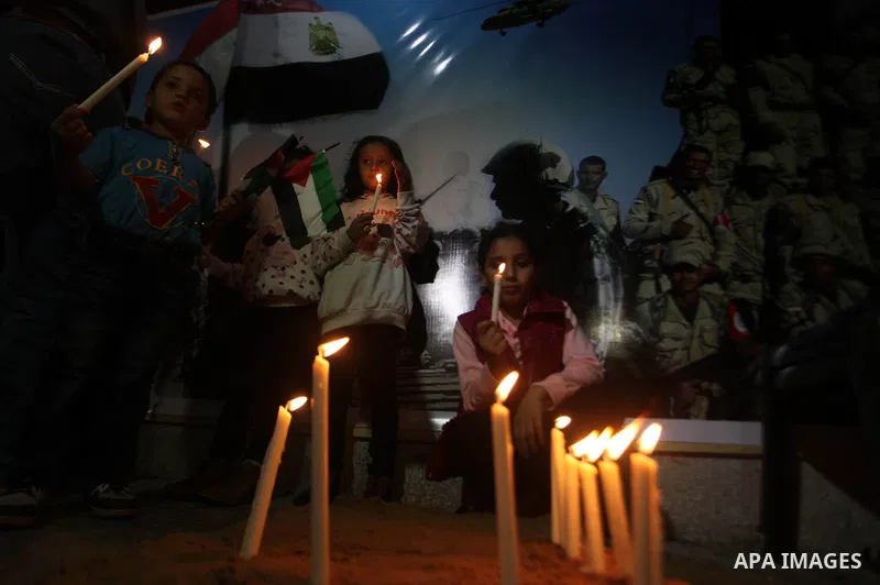 Palestinians light candles to mourn victims of the Egyptian soldiers killed in a suicide attack in Sinai on Friday, at the Egyptian community headquarter in Gaza city October 28, 2014. Cairo shut the vital crossing follo...