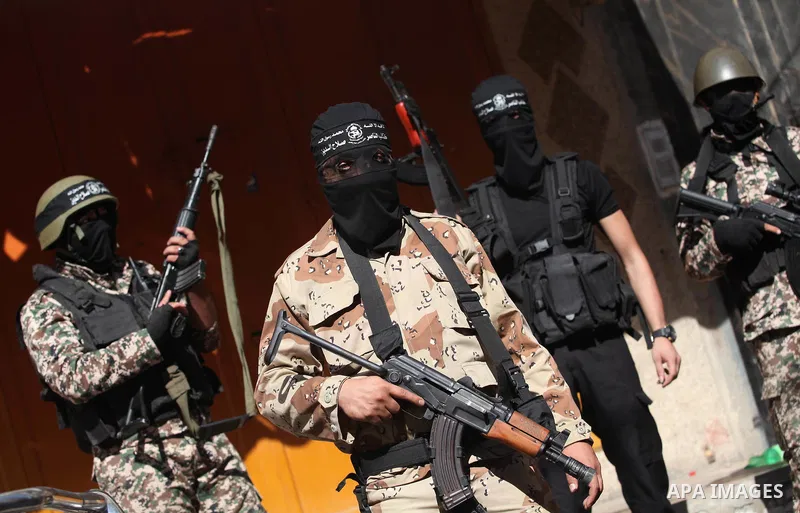 Palestinian militants from the al-Nasser Brigades, an armed wing of the Popular Resistance Committees (PRC), attend a press conference in solidarity with the victims of the Egyptian soldiers who were killed in a suicide...