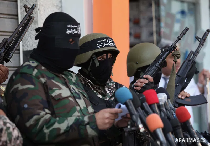 Palestinian militants from the al-Nasser Brigades, an armed wing of the Popular Resistance Committees (PRC), attend a press conference in solidarity with the victims of the Egyptian soldiers who were killed in a suicide...