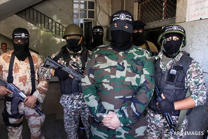Palestinian militants from the al-Nasser Brigades, an armed wing of the Popular Resistance Committees (PRC), attend a press conference in solidarity with the victims of the Egyptian soldiers who were killed in a suicide...