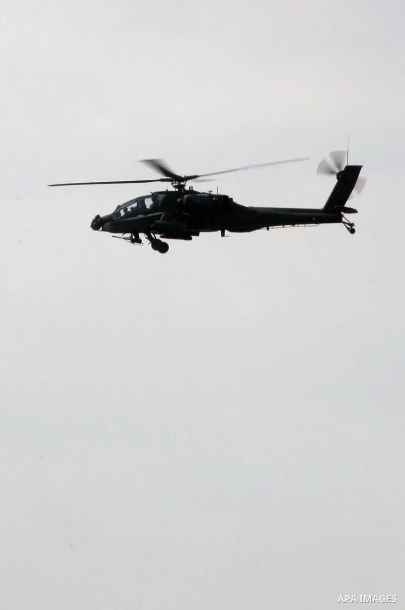 An Egyptian military helicopter hovers over the borders during a military operation to demolish some buildings in the Egyptian city of Rafah near the border with southern Gaza Strip October 29, 2014, as Egypt began setti...