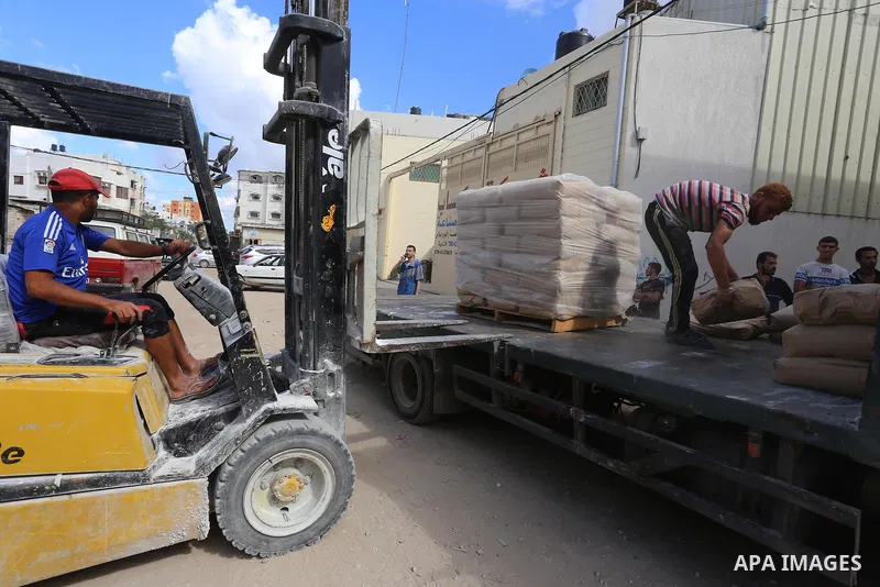 Palestinians receive bags of cement at center in al-Shejaiya neighbourhood in the east of Gaza City, October 30, 2014. More than 100,000 Gaza residents are still homeless. According to reports, Israel has only delivered...