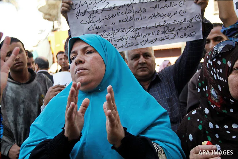 Pro-deposed president Hosni Mubarak Egyptians hold placards during a protest demanding the trial of the revolution leaders, outside the court of cassation, in Cairo on October 30, 2014. Photo by Amr Sayed