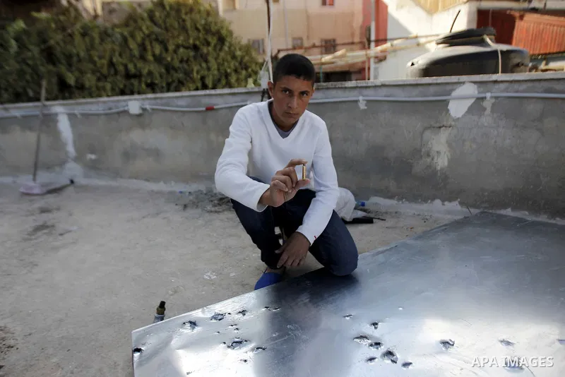 A Palestinian youth displays a bullet at the scene where Moataz Higazi was killed by Israeli security forces on the roof of his house in the mostly Arab east Jerusalem neighbourhood of Abu Tor on October 30, 2014. Hijazi...