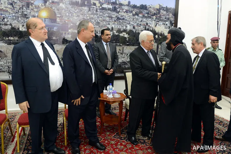 Palestinian President Mahmoud Abbas receives consolations of Arab business leader Said Khoury, who died at the age of 91, at Abbas's headquarter in the West Bank city of Ramallah, October 30, 2014. Palestinian businessma...