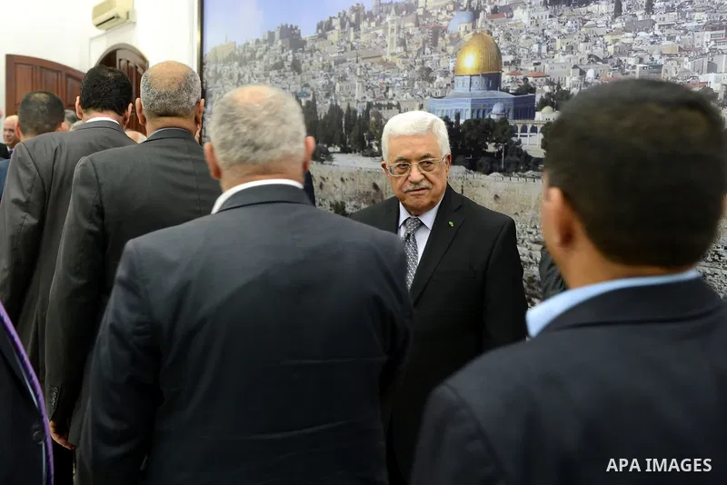 Palestinian President Mahmoud Abbas receives consolations of Arab business leader Said Khoury, who died at the age of 91, at Abbas's headquarter in the West Bank city of Ramallah, October 30, 2014. Palestinian businessma...