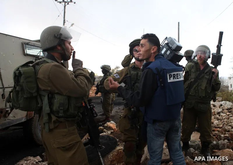 Israeli security forces detain the cameraman of Palestine TV channel during clashes with Palestinian protesters following a rally against the restrictions on the Al-Aqsa mosque compound, in the West Bank village of Silwa...