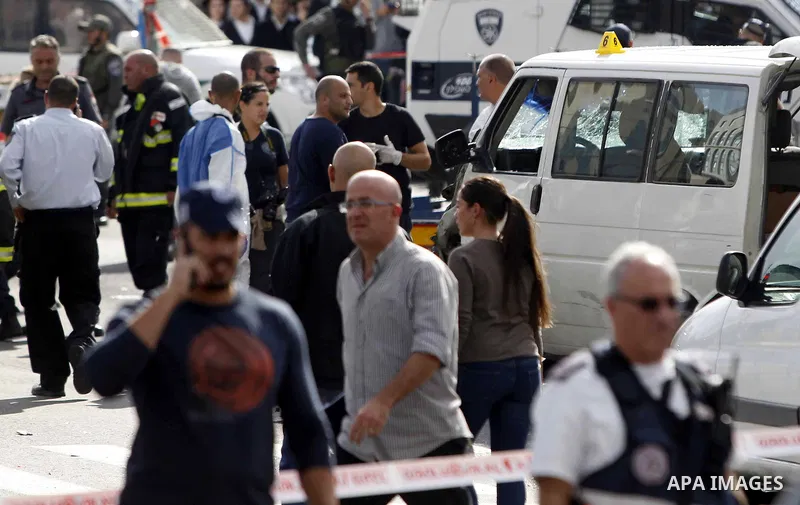 Israeli police and rescue workers inspect the car a Palestinian man used to deliberately rammed it into a crowd of pedestrians in Jerusalem on November 5, 2014. One person was killed and at least nine others wounded. Pol...