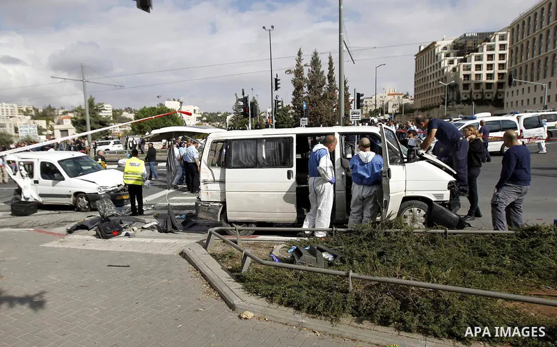Israeli police and rescue workers inspect the car a Palestinian man used to deliberately rammed it into a crowd of pedestrians in Jerusalem on November 5, 2014. One person was killed and at least nine others wounded. Pol...