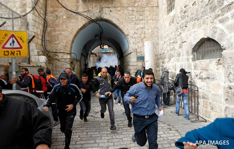 Palestinians run during clashes with Israeli security forces at Jerusalem's flashpoint Al-Aqsa mosque on November 5, 2014. Clashes broke out after far-right Jewish groups announced plans to visit the site despite weeks o...