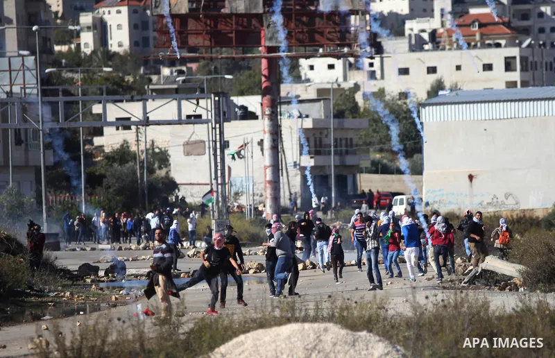 Palestinian students of the Birzeit University throw stones towards Israeli security forces during clashes following an anti-Israel demonstration over the recent entry restrictions to the al-Aqsa mosque, outside Israel's...