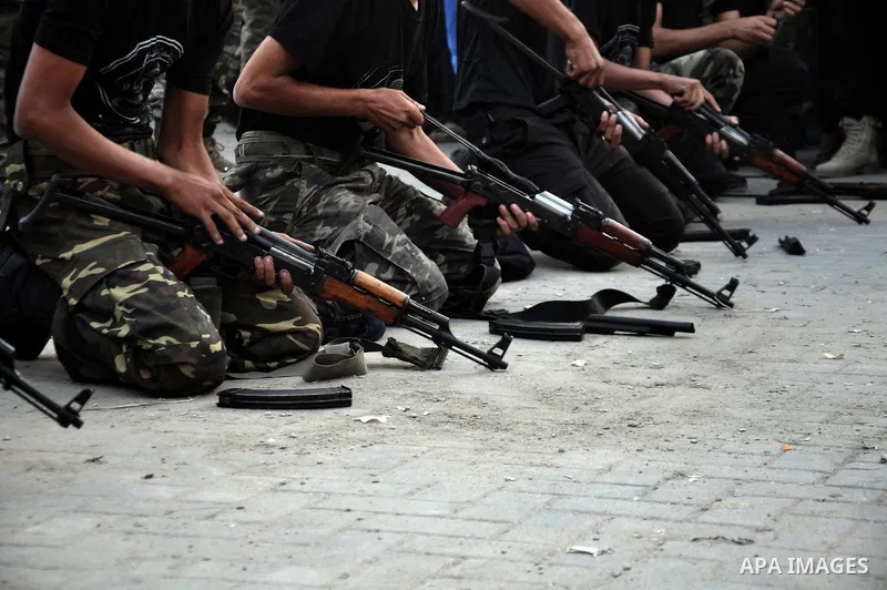 Young Palestinians from Hamas's "popular army" demonstrate their skills during a military graduation ceremony in Jabaliya refugee camp in the northern Gaza Strip November 7, 2014. Hamas recently formed a "popular army" f...