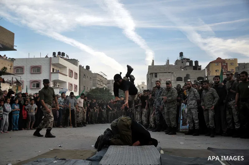 Young Palestinians from Hamas's "popular army" demonstrate their skills during a military graduation ceremony in Jabaliya refugee camp in the northern Gaza Strip November 7, 2014. Hamas recently formed a "popular army" f...