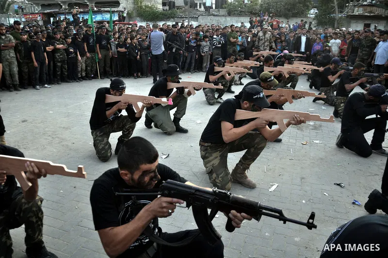Young Palestinians from Hamas's "popular army" demonstrate their skills during a military graduation ceremony in Jabaliya refugee camp in the northern Gaza Strip November 7, 2014. Hamas recently formed a "popular army" f...