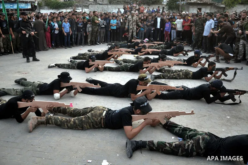 Young Palestinians from Hamas's "popular army" demonstrate their skills during a military graduation ceremony in Jabaliya refugee camp in the northern Gaza Strip November 7, 2014. Hamas recently formed a "popular army" f...